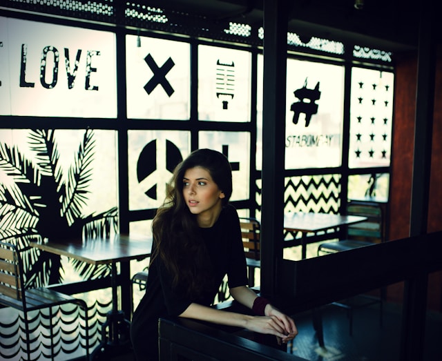 girl in black dress sitting at cafe in Moorabbin looking outside